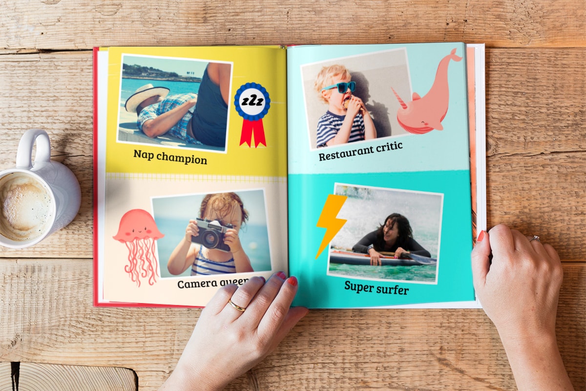 A summer photo book, open on a double-page. There are four photos on the pages; one of a man sleeping in the sun, another of a little girl with a camera, one of a boy with an ice cream, and a photo of a woman surfing.