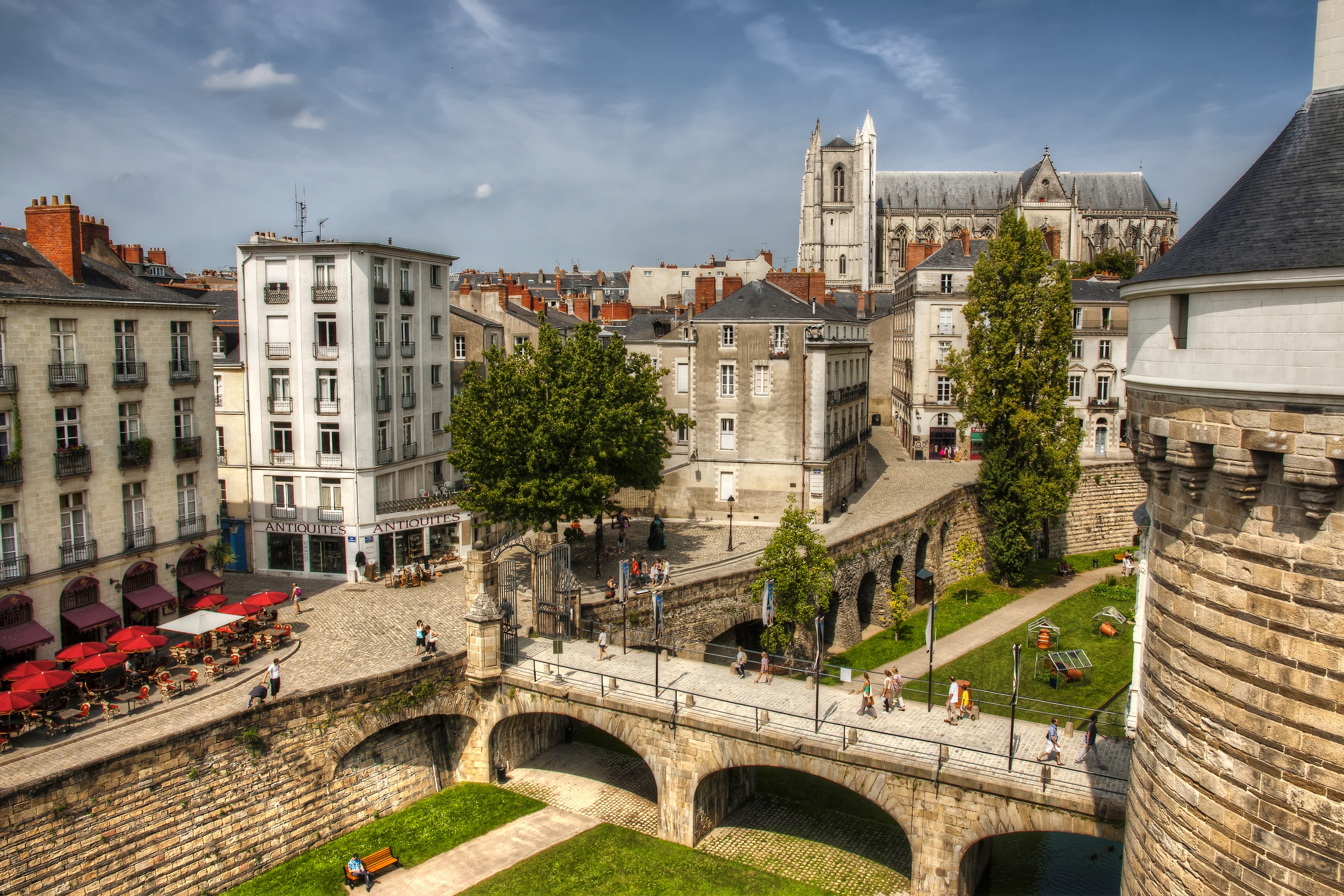 Een foto van Nantes, genomen van bovenaf, met een kathedraal op de achtergrond.